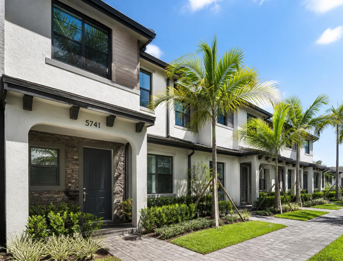 Mora Realty Davie rental realtors Davie FL — modern townhome exterior with palm-lined walkway